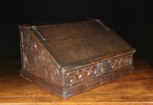 A Large 17th Century Boarded Oak Desk Box having a sloped lid on iron strap hinges with applied