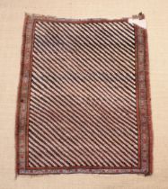 An Antique Caucasian Rug with diagonal striped field in a banded border,