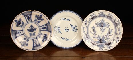 Three Blue & White Delft Plates: One decorated with a feathered edge and floral sprigs 9" (23 cm)