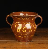 A 19th Century Buckley Earthenware Loving Mug dated in yellow slip 1864 between wiggly slip-ware