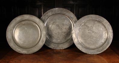 Three Antique Pewter Chargers, 16½" (42 cm), 16¾" (41.5 cm) and 18½" (47 cm) in diameter.