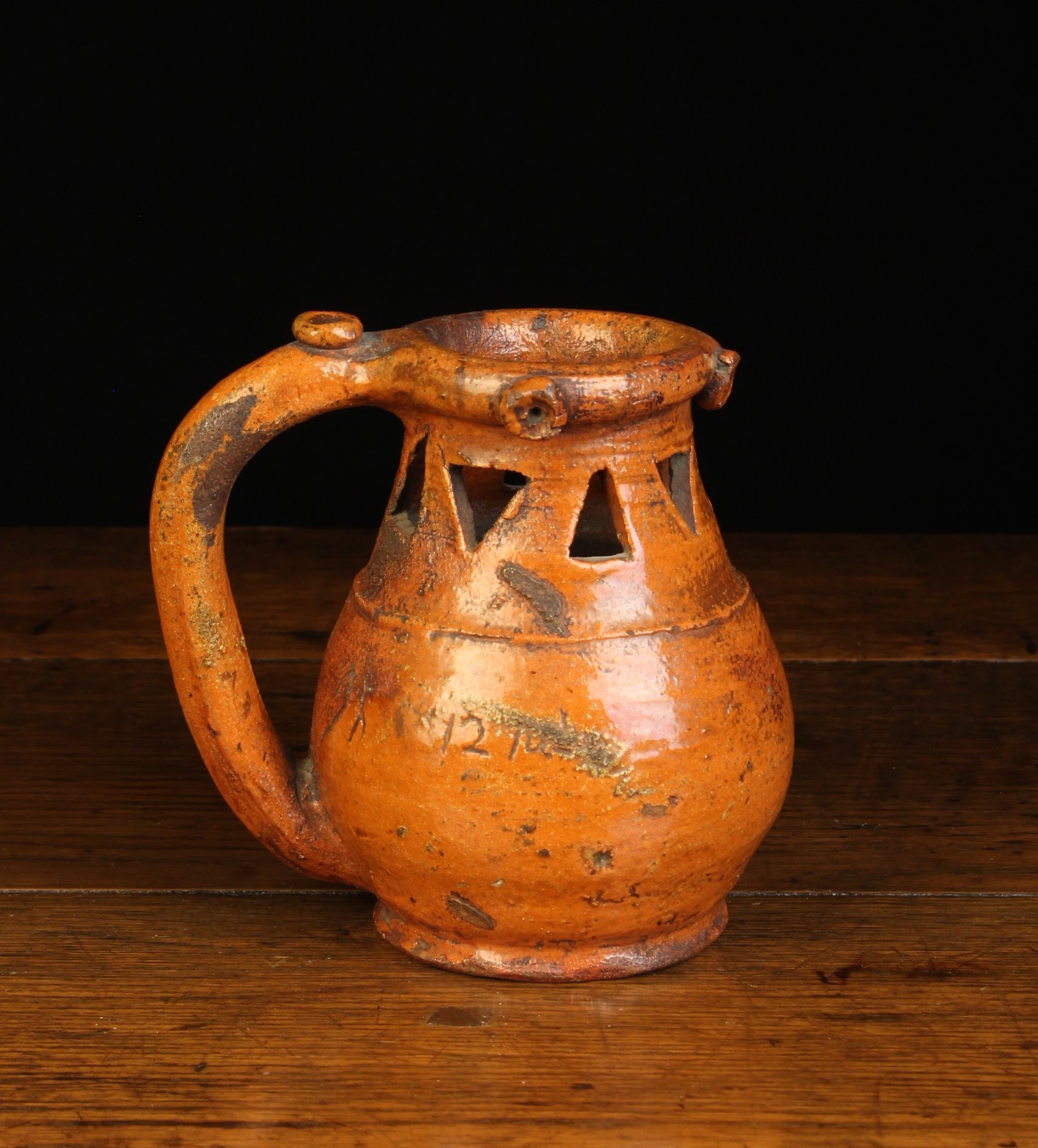 A Small Late 18th Century Orange Glazed Earthenware Puzzle Jug incised with date 1791.