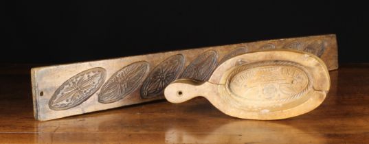 Two 19th Century Treen Culinary Moulds: A long plank carved with eight decorative oval biscuit
