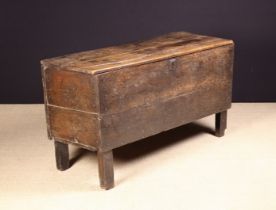 A 17th Century Planked Oak Meal Chest raised on stile feet with an iron escutcheon to the front,