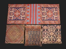 Three Decorative Feather Cushions with Carpet Fragment Panel Covers, and a Kelim Saddle Bag.