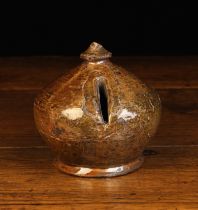 A 17th Century Glazed Earthenware Enclosed Money Box of bulbous form with a finial knop to the top