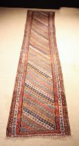 An Antique South Caucasian Runner woven with diagonal bands of small repeated motifs in a multi