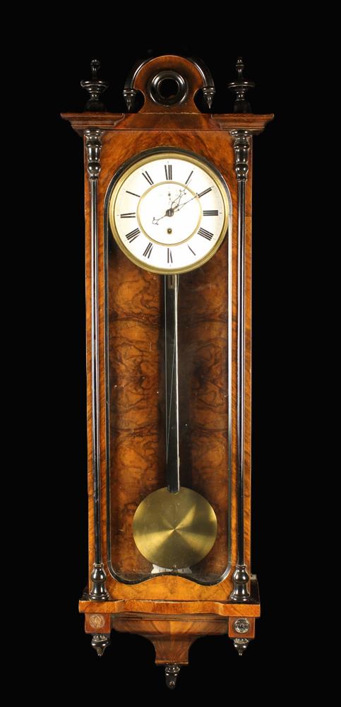 An Antique Vienna Single Weight Wall Clock in a walnut and ebonised case, 44" (112 cm) in length.