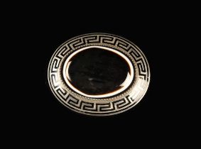 A Bull's Eye Banded Agate Brooch; The oval stone set in a niello mount with key pattern border.