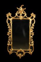 A Modern 'Chippendale' Style Wall Mirror in an open-carved giltwood frame crested with foliage and
