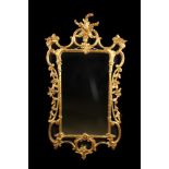 A Modern 'Chippendale' Style Wall Mirror in an open-carved giltwood frame crested with foliage and