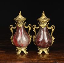A Pair of Small 19th Century Sang de Boeuf glazed Cassolettes with gilt bronze mounts.