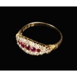 An 18 Carat Gold Lady's Ring set with five graduated oval cut rubies framed by a border of 17 small