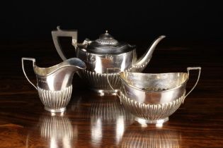 A Small Three Part Silver Teaset; A teapot, sugar basin and jug with reeded sides,
