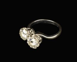 A Fine 18 Carat White Gold & Diamond Ring with a twist of two brilliant cut stones;