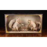 A Vintage Anthropomorphic Taxidermy Display of Two Squirrels sat at a table playing cards,