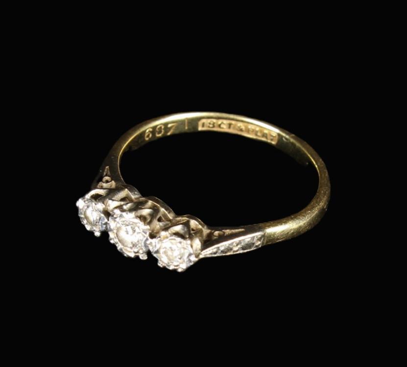 An 18 Carat Lady's Gold Ring set with three diamonds in a platinum setting. UK size N, US 7.