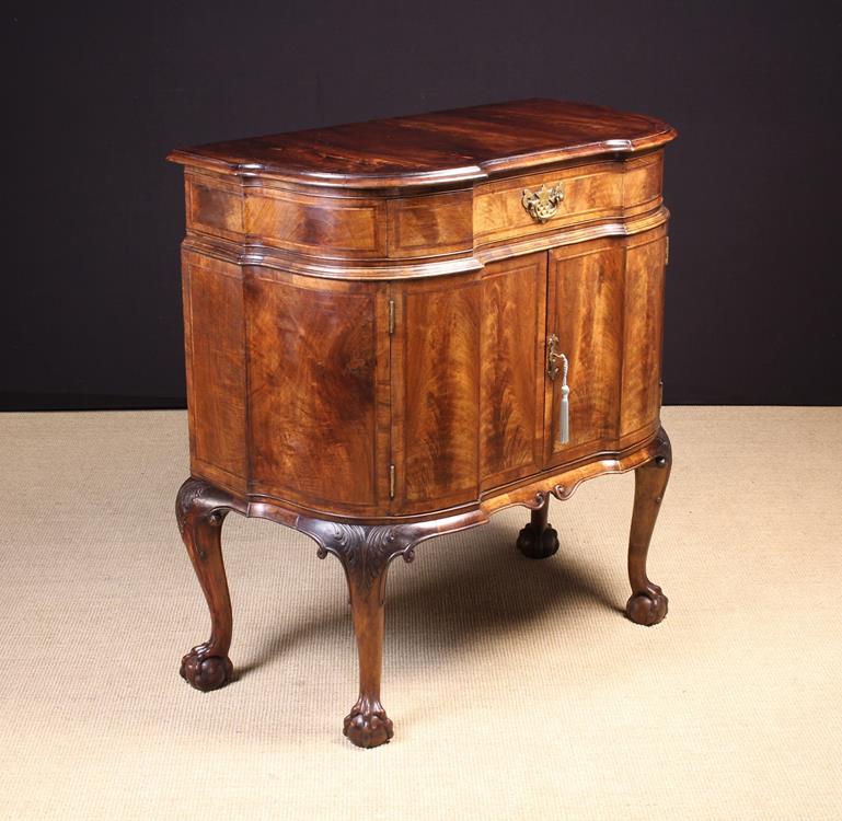 A Vintage Queen Anne Inspired Figured Walnut Serpentine-front Cabinet inlaid with feather banding.