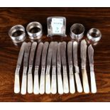 Eleven Mother-of-Pearl handled butter knives with Sterling silver ferrules,