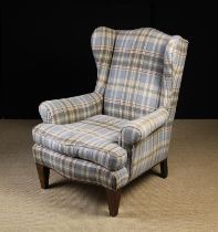 A Vintage Upholstered Wing Armchair covered in a pale blue & grey Harris Tweed Tartan edged with