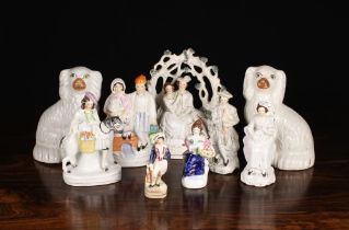 A Group of Victorian Staffordshire Figures: A couple sat under bower encrusted with clumps of