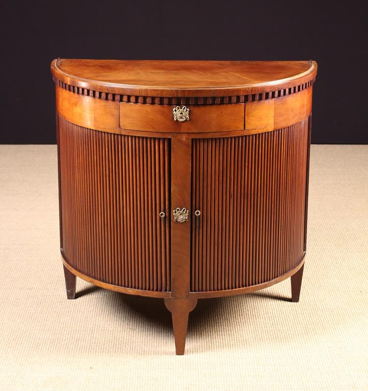 A Mahogany Demi-lune Side Cabinet with tambour front doors below a central frieze drawer,