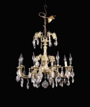 A Vintage Gilt Brass Eight Branch Chandelier hung with facet cut glass drops 21" (53.