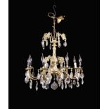 A Vintage Gilt Brass Eight Branch Chandelier hung with facet cut glass drops 21" (53.