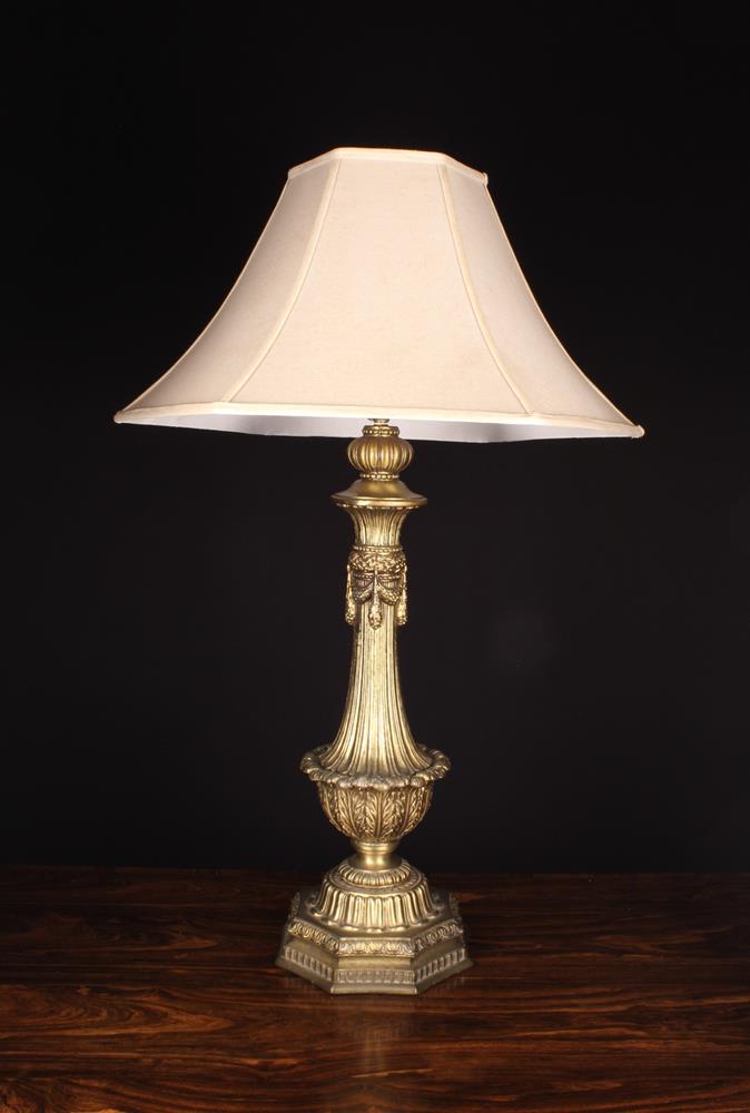 An Ornate Gilt Metal Side Lamp having a fluted body flaring out to an urn shaped bulb of stiff