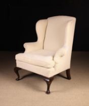 A Georgian Upholstered Wing Armchair covered in an off white herringbone chenille fabric and