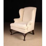 A Georgian Upholstered Wing Armchair covered in an off white herringbone chenille fabric and