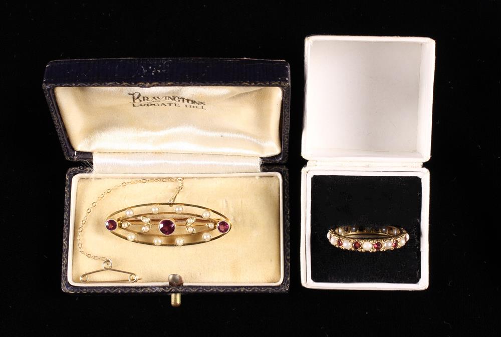 A Nine Carat Gold Eternity Ring set with alternate rubies and pearls,