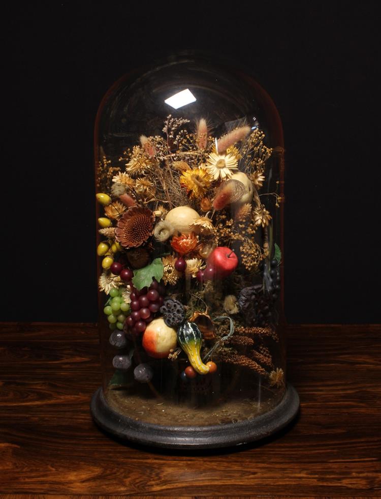 An Arrangement of Dried Flowers and Artificial Fruit displayed beneath a Victorian glass dome with