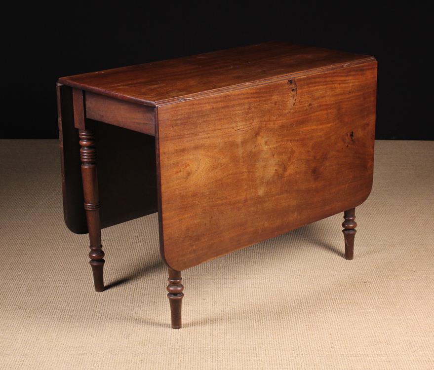 A George IV Mahogany Drop Leaf Dining Table.