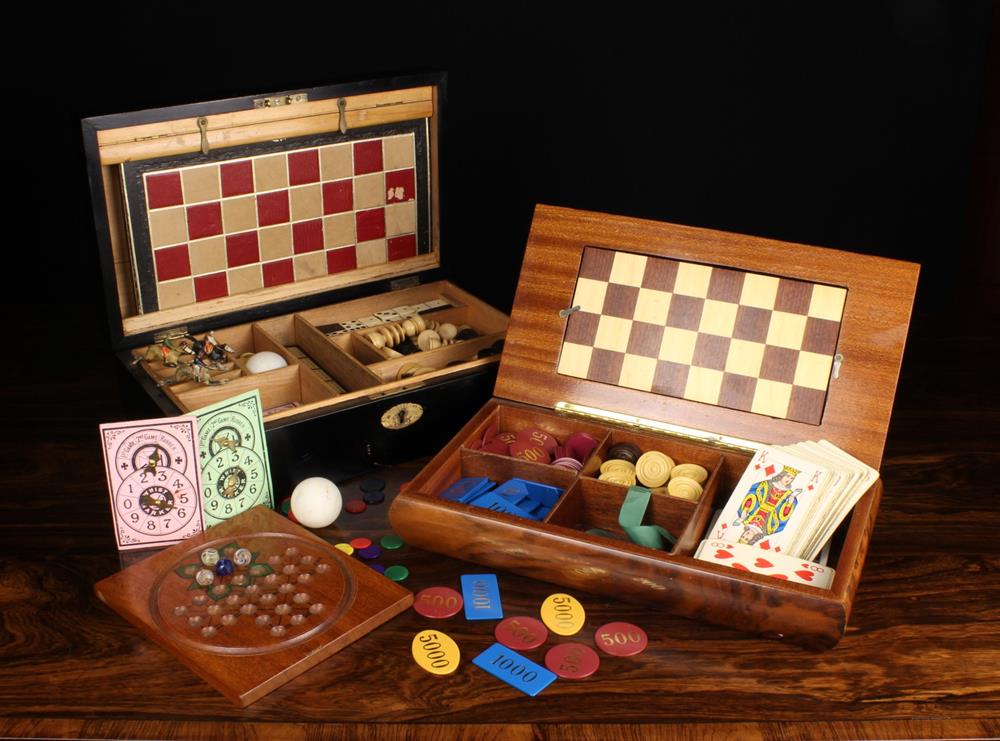 Two Fitted Games Boxes: A late 19th/early 20th century ebonised box with fitted interior housing