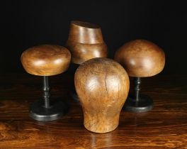 A Vintage Elm Milliner's Head and Three Reproduction Milliner's Stands on turned and ebonised
