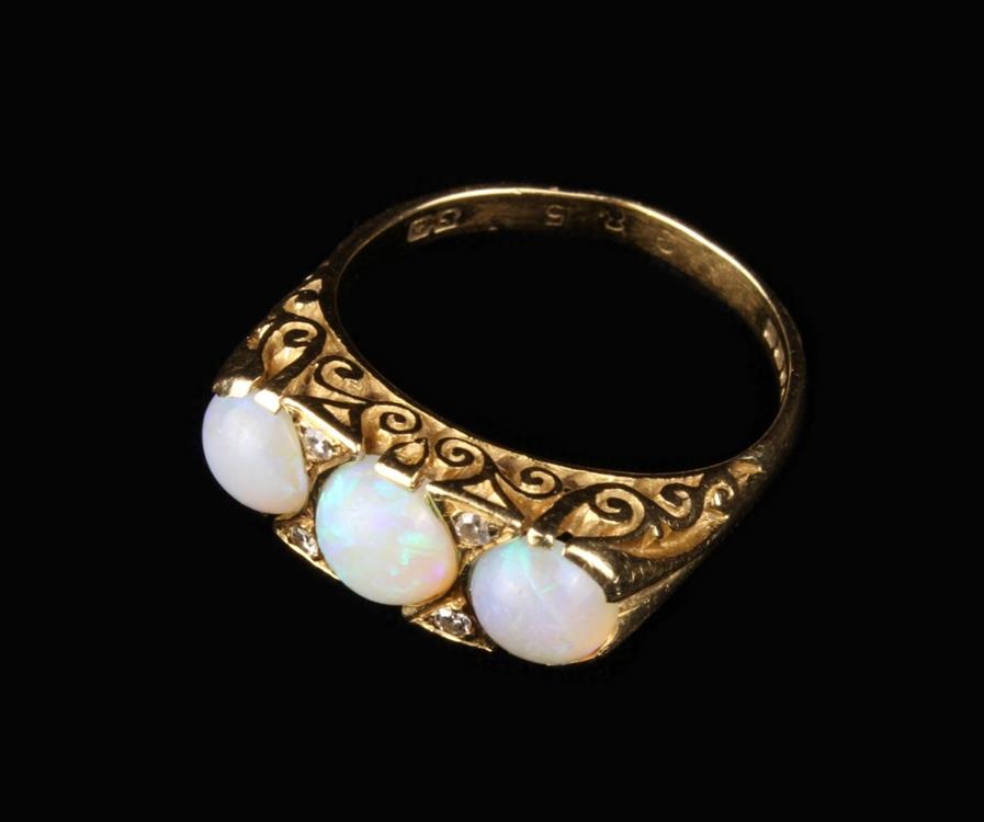 An 18 Carat Gold & Opal Ring set with three cabochon stones. UK size O/P, US 7.5.