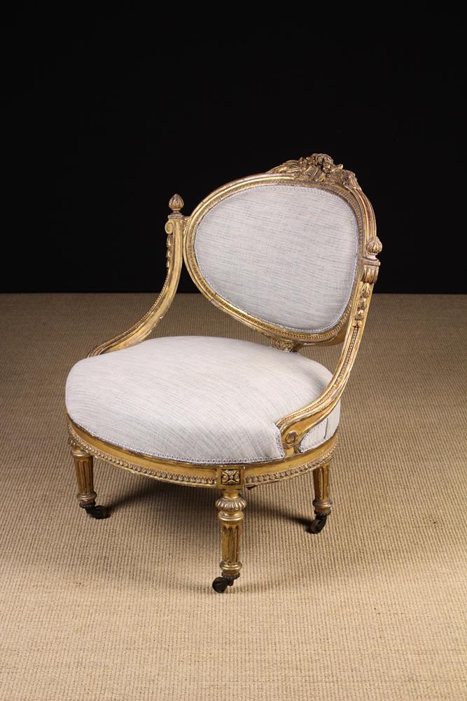 A 19th Century Louis XVI Style Low Upholstered Salon Chair with an oval padded back and a broad