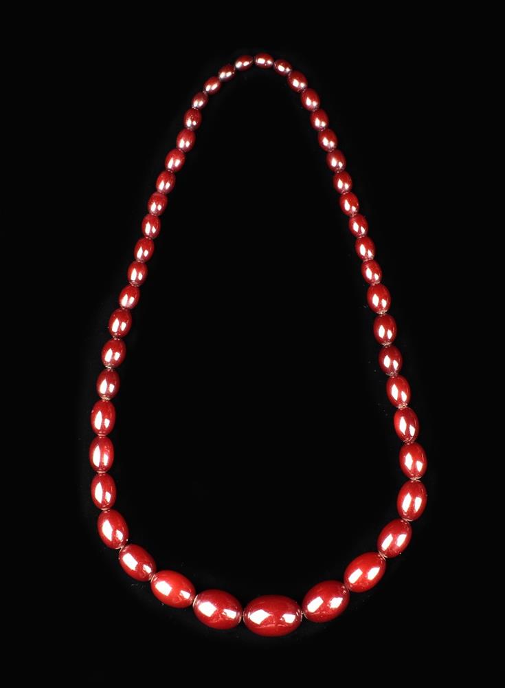 A Cherry Amber Necklace of graduated oval beads (approx 72 g).