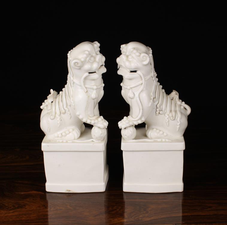 A Pair of Late 19th Century Blanc de Chine Porcelain Dogs of Fo on rectangular plinths, - Image 2 of 2