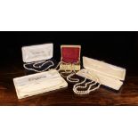 Eight Simulated Pearl Necklaces: A twin strand necklace with diamonté clasp in a case marked