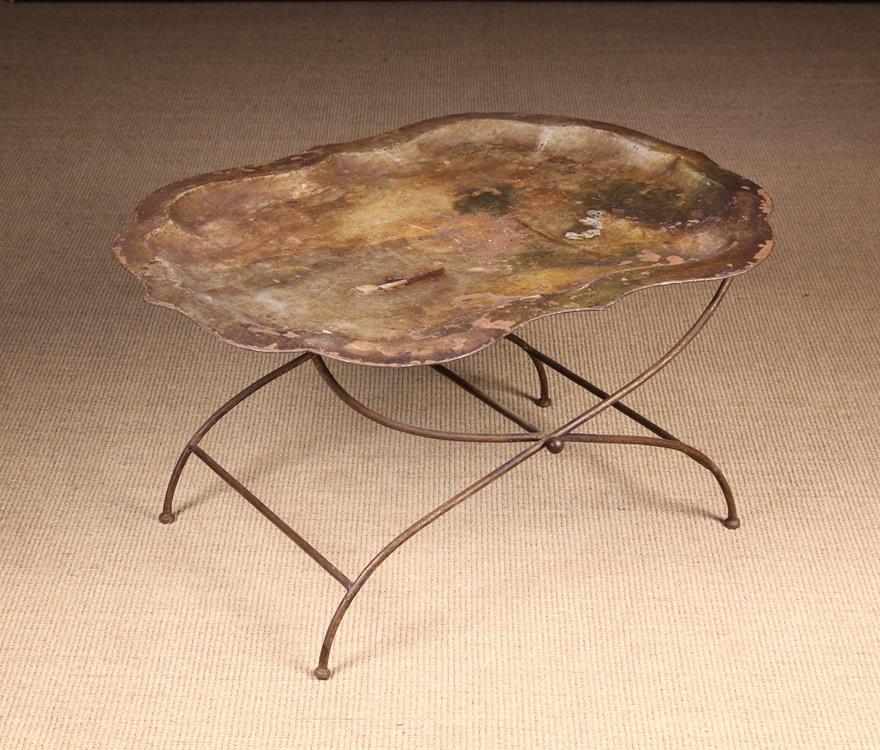 A Georgian Tôleware Serpentine Tray (A/F) on a folding iron stand.