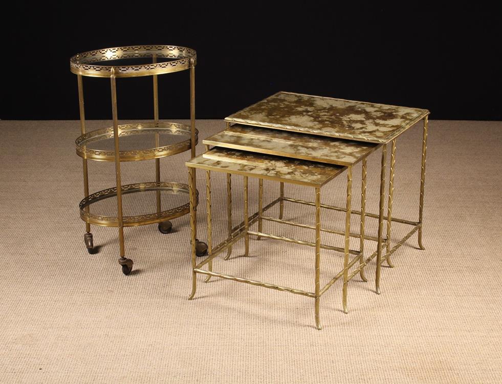 A three-tier glass & gilt brass tea-trolley with decoratively pierced gallery rails 27" (69 cm)