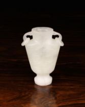 A Small White Jade Vase carved with face masks to the flattened sides and having loop handles