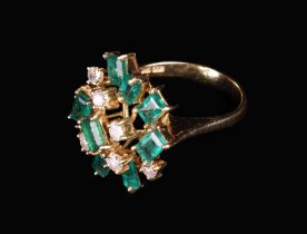 A 14 Carat Gold Lady's Cluster Ring set with an irregular arrangement of nine emeralds and seven