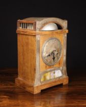 An Arts & Crafts Oak Cased Mantel Clock with an inset coloured dappled glass panel to the base and