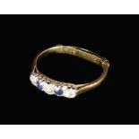 A 9 Carat Gold Lady's Ring set with three diamonds flanking two sapphires, housed in an old W.H.
