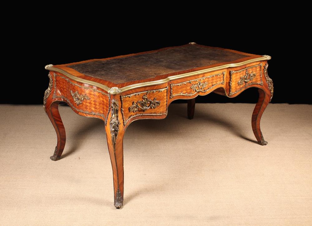 An Imposing Louis XV Style Bureau Plat clad in diagonally grained tulip wood veneers with diamond