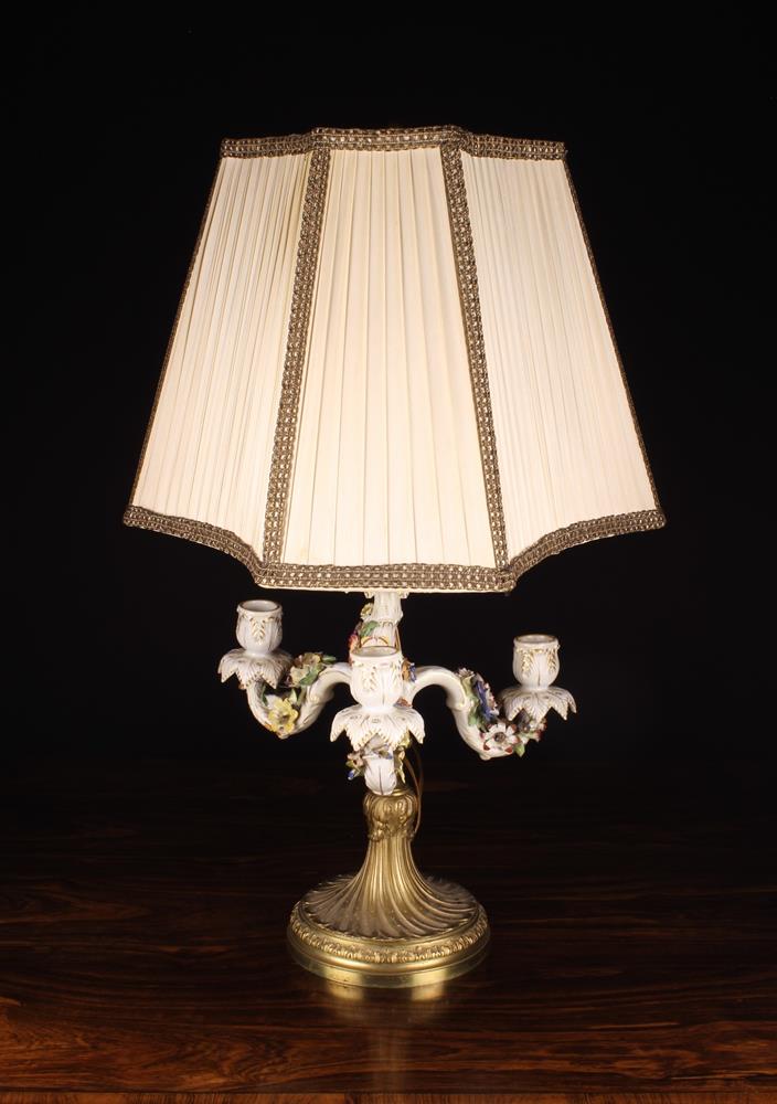 A Converted 19th Century Porcelain Three Branch Candelabra (A/F) The scrolling arms encrusted with