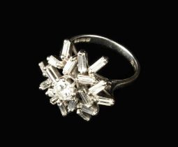 An 18 Carat White Gold Cluster Ring set with baguette cut diamonds around a brilliant cut diamond